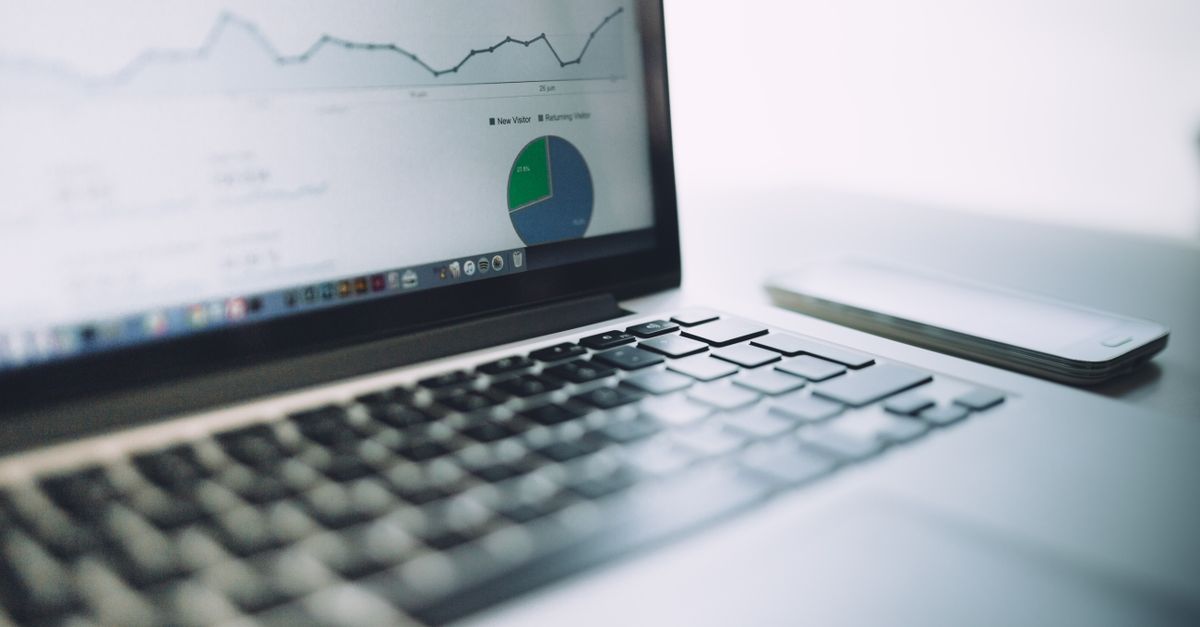 A laptop showing an analytics dashboard with charts and graphs, symbolizing modern data analysis tools.
