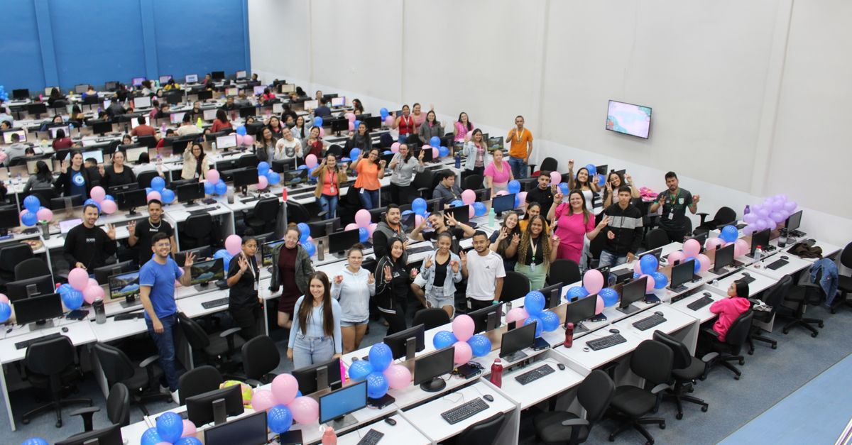 Cheerful office celebration with colorful balloons and diverse team indoors.
