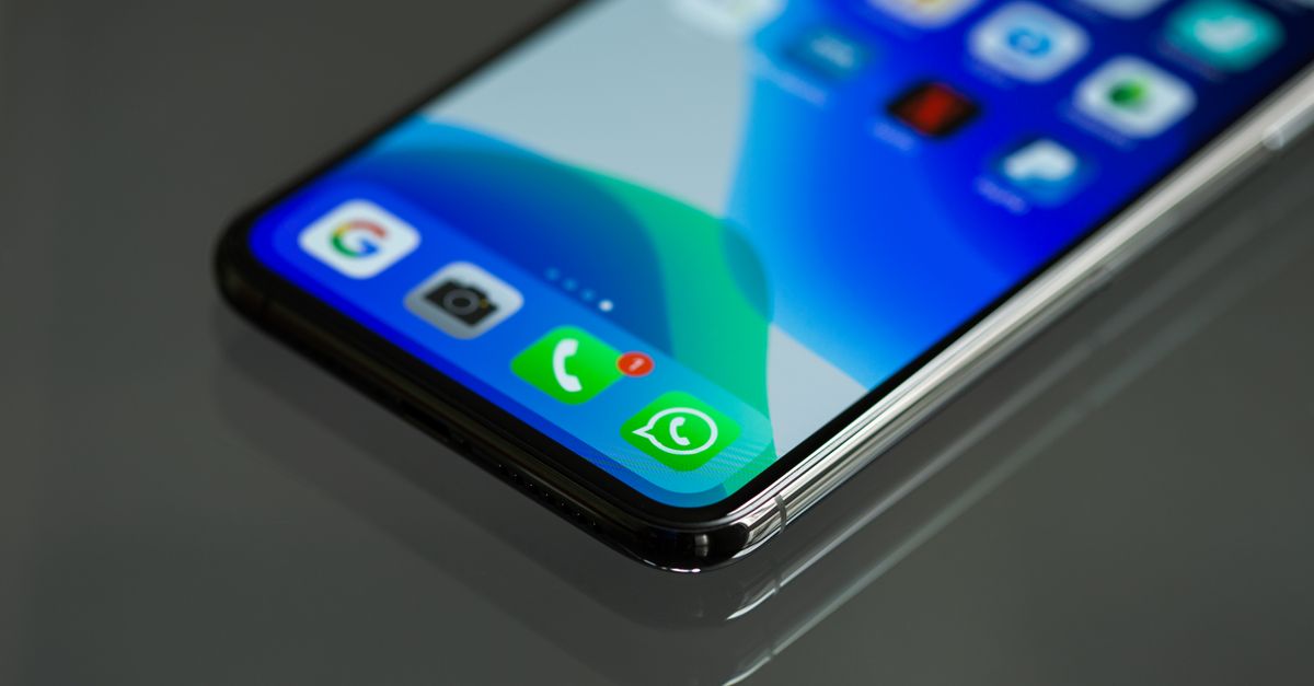 Close-up shot of a smartphone screen displaying various app icons including WhatsApp.
